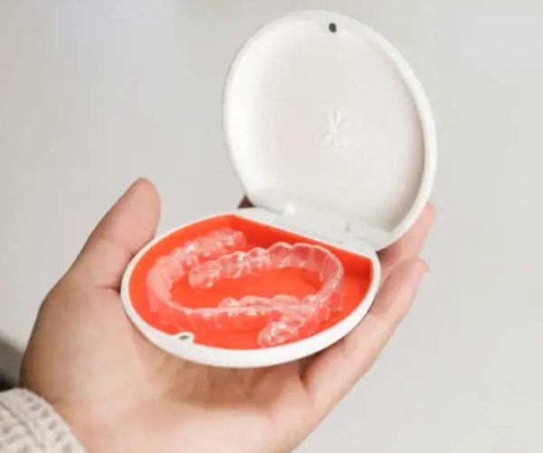 Photo-text-media-Invisalign-aligners-in-orange-case